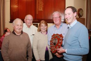 President Ken presents the winner's shield to Govan Rotary team.